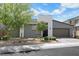 Beautiful gray stucco single-story home with a desert landscape in the front yard at 1609 Dream Canyon Ave, North Las Vegas, NV 89084