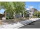Charming gray stucco single-story home with desert landscaping and a brick pathway to the front at 1609 Dream Canyon Ave, North Las Vegas, NV 89084