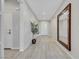 Bright hallway featuring wood-look floors, decorative trim, and a large mirror at 1609 Dream Canyon Ave, North Las Vegas, NV 89084