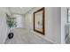Inviting hallway features stylish wood-look tile flooring, decorative wall accents, and a large mirror at 1609 Dream Canyon Ave, North Las Vegas, NV 89084
