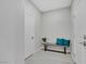 Small hallway featuring a gray bench with turquoise pillows and wood-look floors at 1609 Dream Canyon Ave, North Las Vegas, NV 89084