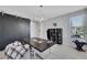 Home office featuring a black desk, large window, modern light fixture and dark sliding door at 1609 Dream Canyon Ave, North Las Vegas, NV 89084
