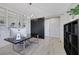 Bright home office featuring built-in shelving, a dark desk, modern lighting and neutral walls at 1609 Dream Canyon Ave, North Las Vegas, NV 89084