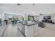 Spacious kitchen with white cabinetry, stainless steel appliances, an island with breakfast bar, and wood-look tile at 1609 Dream Canyon Ave, North Las Vegas, NV 89084