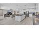 Open-concept kitchen with white cabinets, stainless steel appliances, and a large island with a view of living room at 1609 Dream Canyon Ave, North Las Vegas, NV 89084