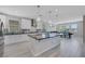 Bright kitchen features a large island, stainless appliances, and white cabinets at 1609 Dream Canyon Ave, North Las Vegas, NV 89084
