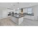 Modern kitchen with white cabinets, stainless steel appliances, an island with pendant lighting, and tile backsplash at 1609 Dream Canyon Ave, North Las Vegas, NV 89084