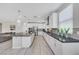 Bright kitchen featuring white cabinetry, stainless steel appliances, and a spacious island for food preparation at 1609 Dream Canyon Ave, North Las Vegas, NV 89084