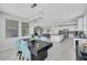 Open floor plan with dining area flowing into the modern kitchen and living room at 1609 Dream Canyon Ave, North Las Vegas, NV 89084
