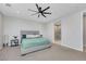 Comfortable main bedroom featuring plush carpet, fan, and ensuite bathroom at 1609 Dream Canyon Ave, North Las Vegas, NV 89084