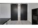 Dark sliding barn doors leading to another room with a black bookcase and a dark desk at 1609 Dream Canyon Ave, North Las Vegas, NV 89084
