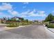 Neighborhood street with brick pavers, landscaped median, and mountain views at 1609 Dream Canyon Ave, North Las Vegas, NV 89084