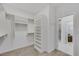 Well-organized walk-in closet with custom shelving units and a doorway leading to the bathroom at 1609 Dream Canyon Ave, North Las Vegas, NV 89084