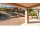 Backyard showing a covered patio with a view of the landscaped yard with retaining walls at 2037 Poppywood Ave, Henderson, NV 89012