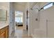 Bright bathroom featuring a tiled shower stall and tile flooring plus access to the main bedroom at 2037 Poppywood Ave, Henderson, NV 89012
