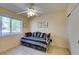 Cozy bedroom filled with natural light, featuring a window view and a comfortable bed with striped throw pillows at 2037 Poppywood Ave, Henderson, NV 89012