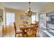 Bright dining area with hardwood floors, chandelier, and a sliding door to the backyard at 2037 Poppywood Ave, Henderson, NV 89012