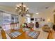 Bright dining area with hardwood floors, a chandelier, and a view of the living room at 2037 Poppywood Ave, Henderson, NV 89012