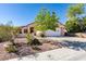 Charming single-story home with desert landscaping and a two-car garage on a sunny day at 2037 Poppywood Ave, Henderson, NV 89012