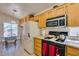 Efficient kitchen with gas range, stainless microwave, and an adjacent breakfast nook at 2037 Poppywood Ave, Henderson, NV 89012