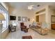 Comfortable living area with leather seating, a ceiling fan, and lots of natural light from a large window at 2037 Poppywood Ave, Henderson, NV 89012