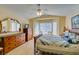 Spacious bedroom with natural light, hardwood floors, and a bay window at 2037 Poppywood Ave, Henderson, NV 89012