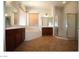 Bathroom featuring double sinks, bathtub, and separate shower at 2324 Orangeburg Pl, Henderson, NV 89044