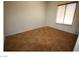 A bedroom with neutral walls, a window with blinds and neutral tile floor at 2324 Orangeburg Pl, Henderson, NV 89044
