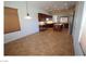 Spacious kitchen and dining area with dark wood cabinets, stainless steel appliances, and tile floors at 2324 Orangeburg Pl, Henderson, NV 89044