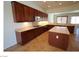 Modern kitchen with dark wood cabinets, stainless steel appliances, and a center island at 2324 Orangeburg Pl, Henderson, NV 89044