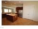 Open kitchen layout with stainless steel appliances, an island, and adjacent dining space at 2324 Orangeburg Pl, Henderson, NV 89044