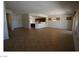 Spacious open-plan living area with tiled floors and access to kitchen and dining area at 2324 Orangeburg Pl, Henderson, NV 89044
