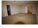 Spacious living room featuring neutral carpet and access to other rooms at 2324 Orangeburg Pl, Henderson, NV 89044