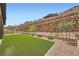 Well maintained backyard featuring artificial turf with custom rock retaining wall at 243 Sun Glaze Ave, Henderson, NV 89011