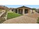 Landscaped backyard featuring a manicured lawn, rock landscaping, and patio at 243 Sun Glaze Ave, Henderson, NV 89011