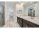 Bathroom featuring double sinks, a walk-in closet, and a glass walk-in shower at 243 Sun Glaze Ave, Henderson, NV 89011