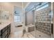 Bathroom featuring a glass walk-in shower and tile flooring, and a view into the bedroom at 243 Sun Glaze Ave, Henderson, NV 89011