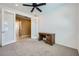 Bedroom with light-colored carpet, a ceiling fan, a wooden desk, and two glass doors at 243 Sun Glaze Ave, Henderson, NV 89011
