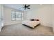 Bedroom with light-colored carpet, a ceiling fan, a window, and a king-size bed at 243 Sun Glaze Ave, Henderson, NV 89011