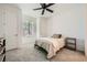 Well-lit bedroom with a neutral color scheme, carpeted floors, and a ceiling fan at 243 Sun Glaze Ave, Henderson, NV 89011