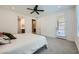 Bedroom with light-colored carpet, a ceiling fan, a glass door, and a king-size bed at 243 Sun Glaze Ave, Henderson, NV 89011