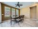 Dining room with a wooden table, six chairs, tile flooring, and three windows at 243 Sun Glaze Ave, Henderson, NV 89011