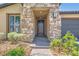 Close up of the home's entrance with stone pillars, a paved walkway, and neutral landscaping at 243 Sun Glaze Ave, Henderson, NV 89011