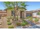 Attractive single-story home with stone accents, low maintenance landscaping, and a brick paved walkway at 243 Sun Glaze Ave, Henderson, NV 89011