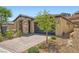 Charming single-story home with stone facade, neutral paint, dark garage door and low maintenance landscaping at 243 Sun Glaze Ave, Henderson, NV 89011