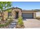 Charming single-story home featuring stone accents, low maintenance landscaping, and a brick paved driveway at 243 Sun Glaze Ave, Henderson, NV 89011