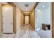 Long hallway with wood floors, neutral paint, and access to rooms with white doors at 243 Sun Glaze Ave, Henderson, NV 89011
