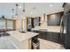 Open concept kitchen featuring a quartz countertop island, stainless steel appliances, and pendant lighting at 243 Sun Glaze Ave, Henderson, NV 89011