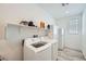 Functional laundry room with washer, dryer, utility sink, and storage cabinets at 243 Sun Glaze Ave, Henderson, NV 89011