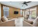 Bright living room with neutral colored walls, wood floors, a ceiling fan, and access to the backyard at 243 Sun Glaze Ave, Henderson, NV 89011